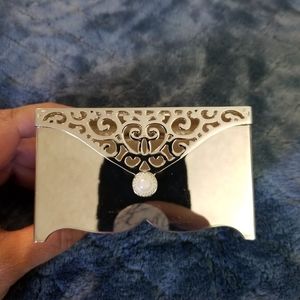 A silver jewelry box with bracelet